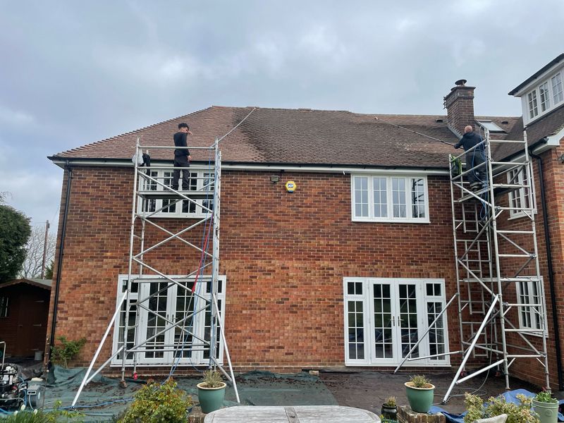 Roof cleaning carried out safely from scaffold towers by The Roof Moss Cleaners in Hitchin